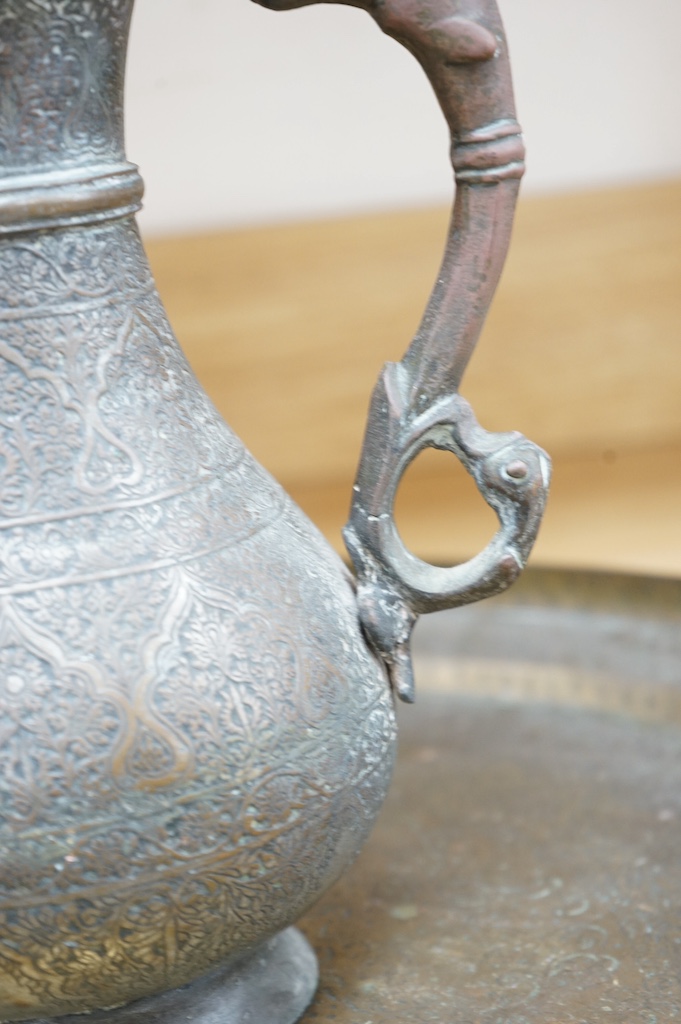 A Kashmiri brass lidded tea pot and tray, teapot 35cm high, tray 50cm diameter. Condition - fair to good